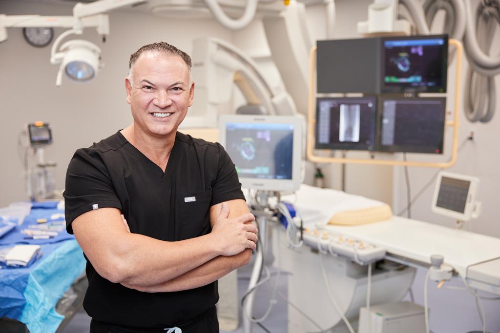 Dr. Pedro Martinez-Clark, Harvard-trained interventional cardiologist in Miami, wearing a royal blue suit